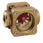 Brass FR flow indicator with a transparent viewing window and red turbine rotor, designed for visual monitoring of liquid flow in industrial piping systems.